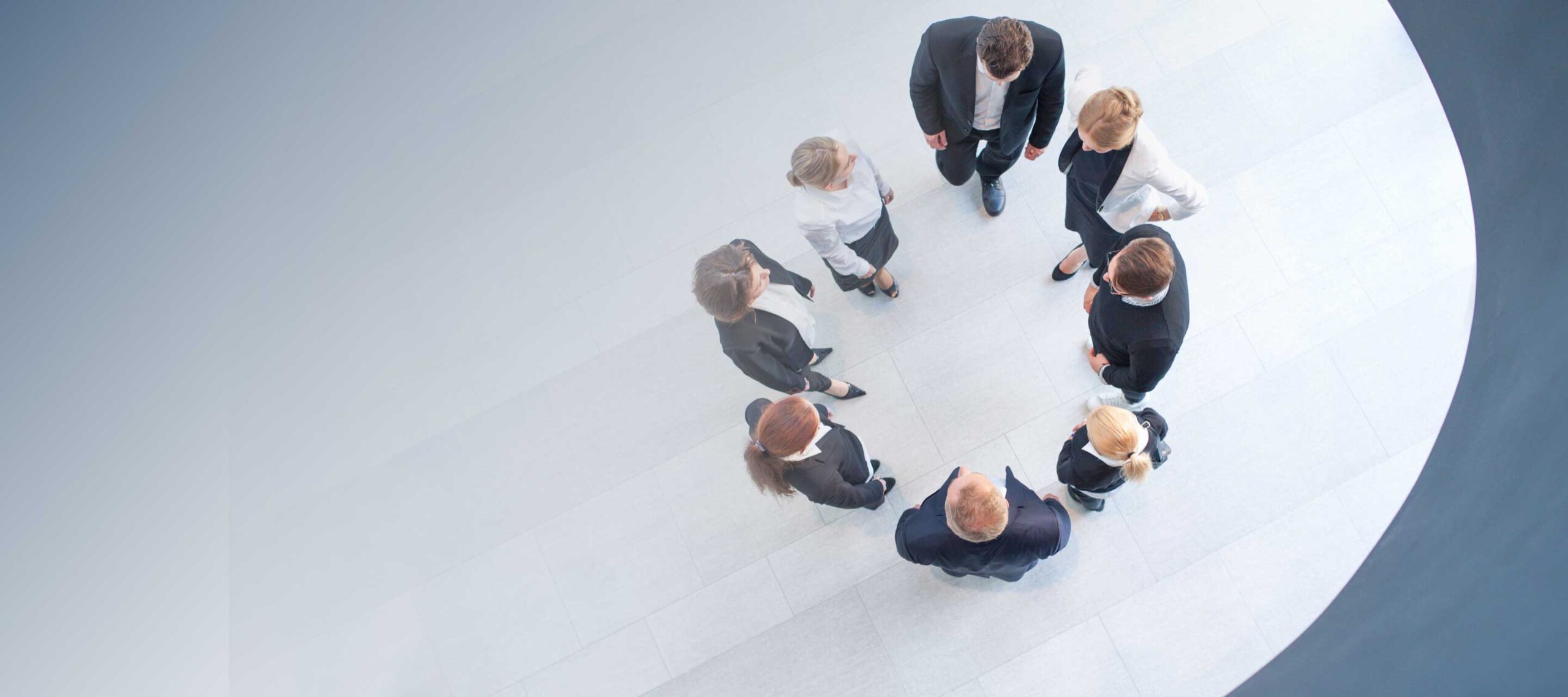 Overhead shot of people standing in circle having a meeting
